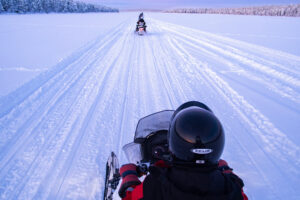 00-snowmobiling-on-the-frozen-lake-at-sunset-at-toras-2022-03-05-21-17-16-utc