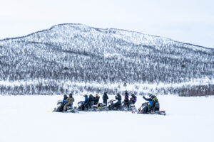 00-snowy-day-with-people-riding-the-snowmobiles-and-a-2023-02-01-18-52-53-utc
